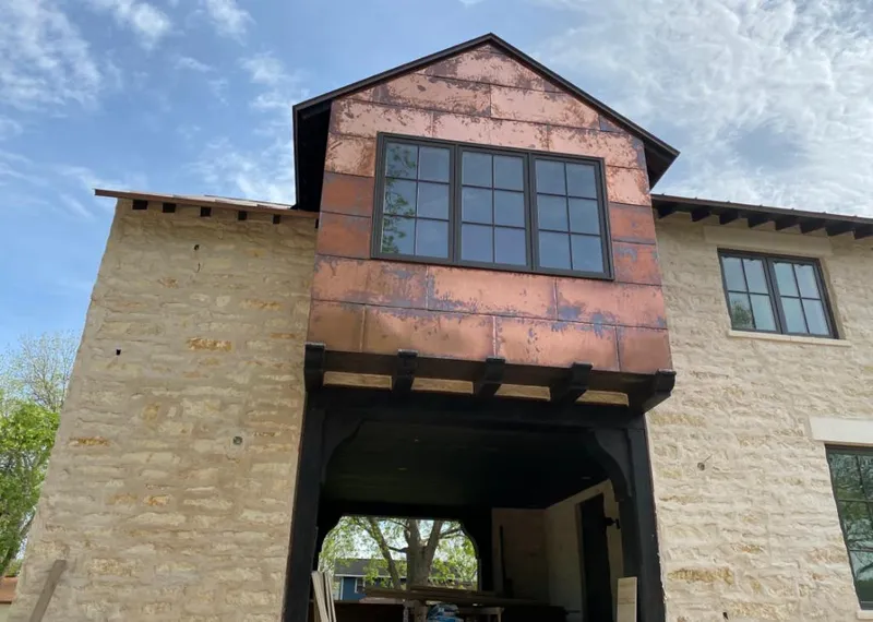 Copper metal panel facade on a stone building for Metal Roof Coating in Natchitoches