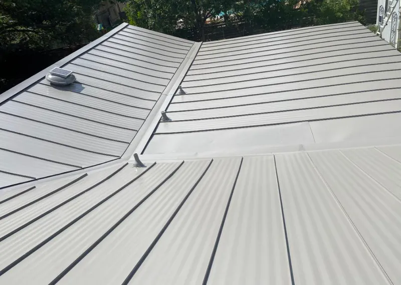 Solar attic fan installed on a metal roof for Roof Ventilation in Natchitoches